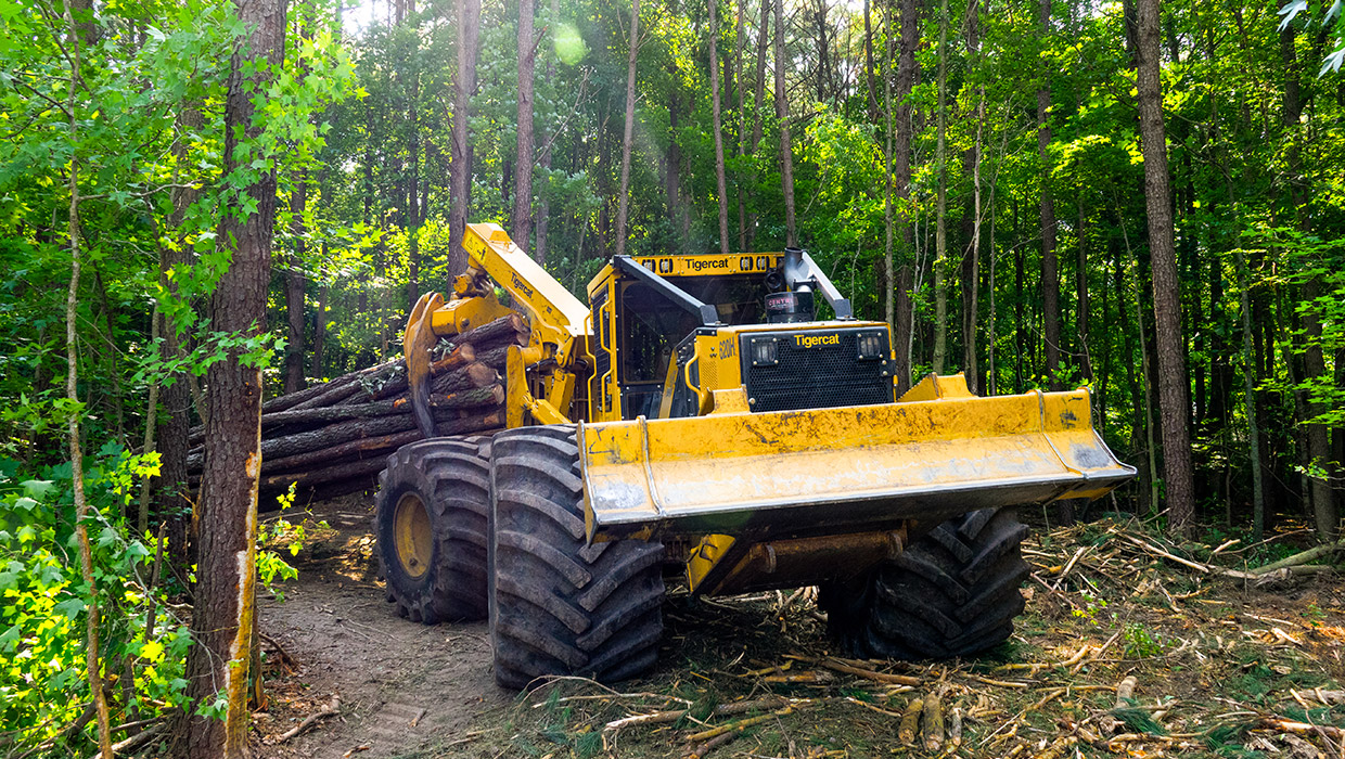 Image of a 620H skidder working in the field