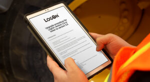 Logger looking at a tablet with Logon instructions beside his machine